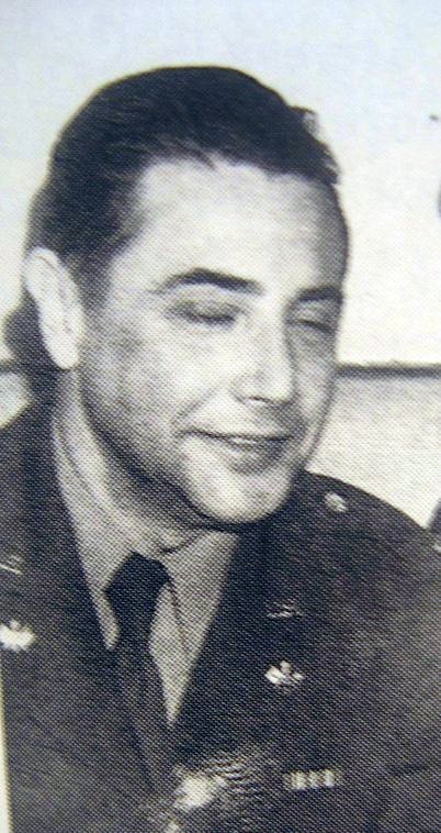 a man smiling for the camera wearing a uniform
