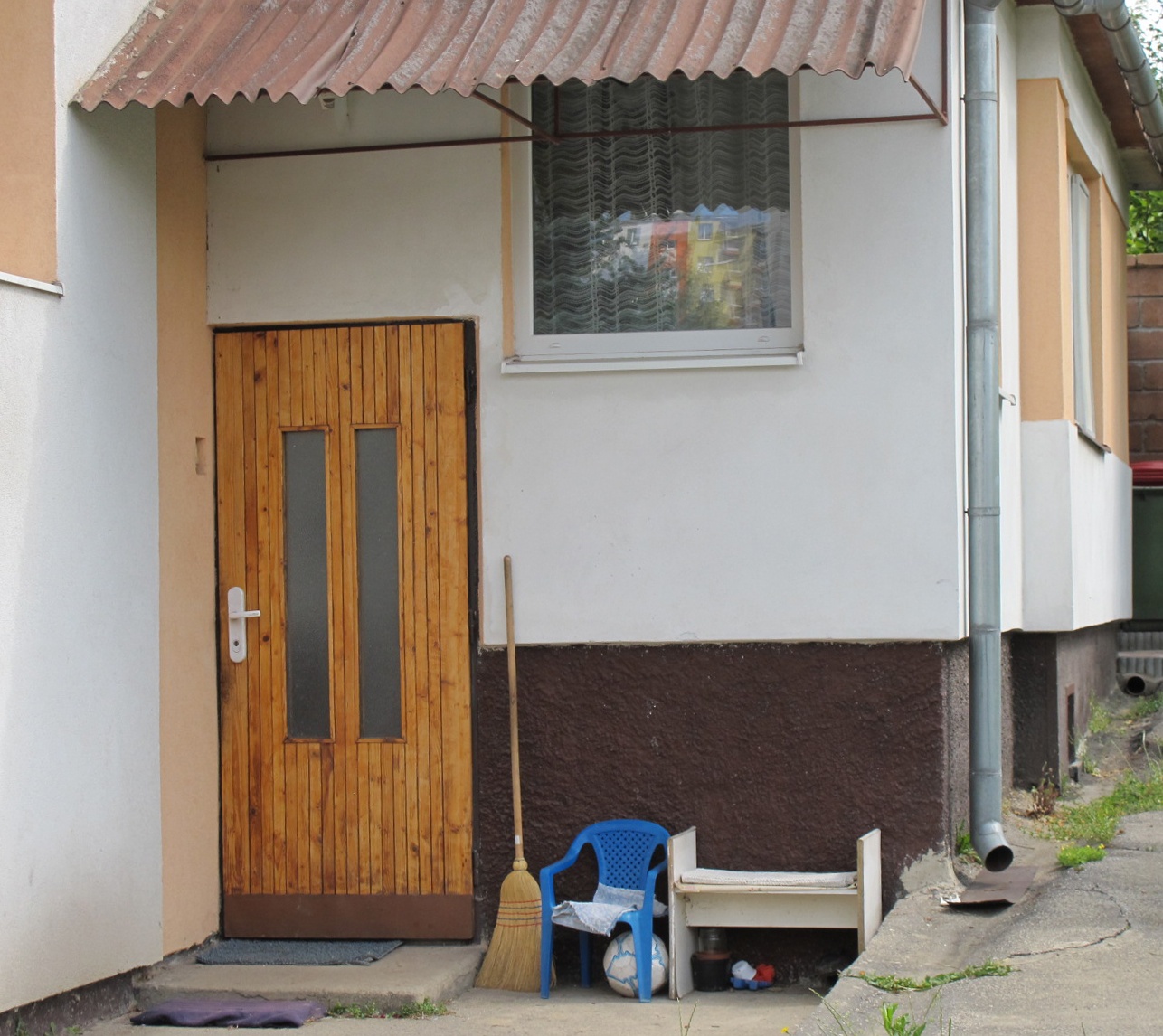 a wooden door on the side of a house