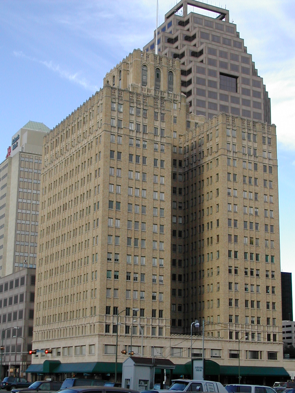 large tan building near parking spaces in a downtown area