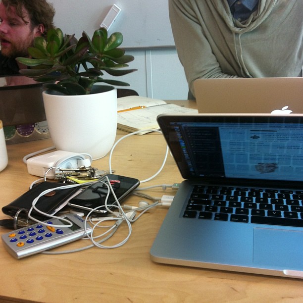 a couple of laptops sitting on top of a table