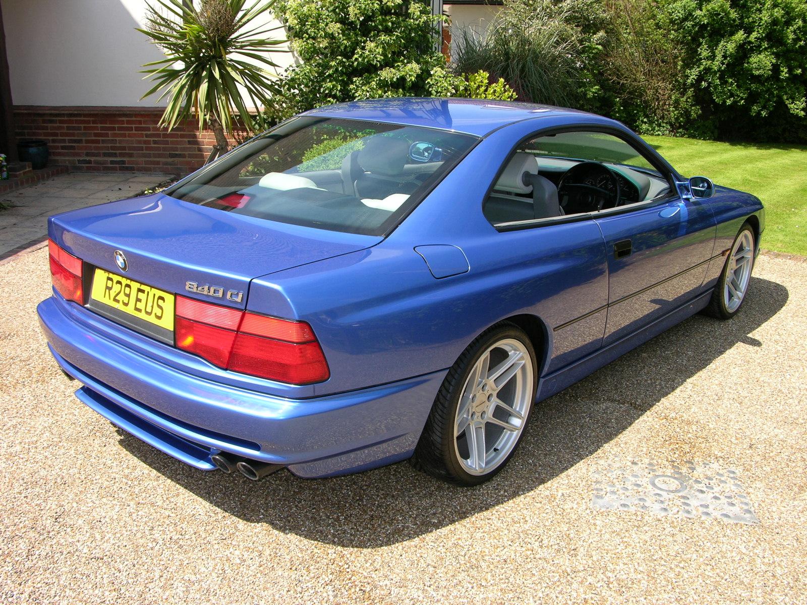 a blue sports car parked in front of a house