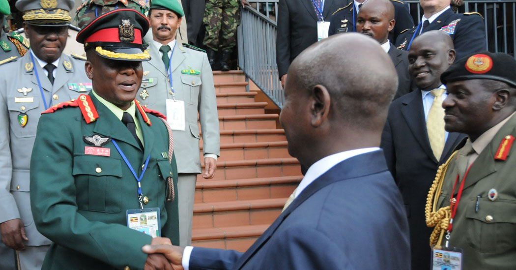 a man in military uniform shakes hands with another man