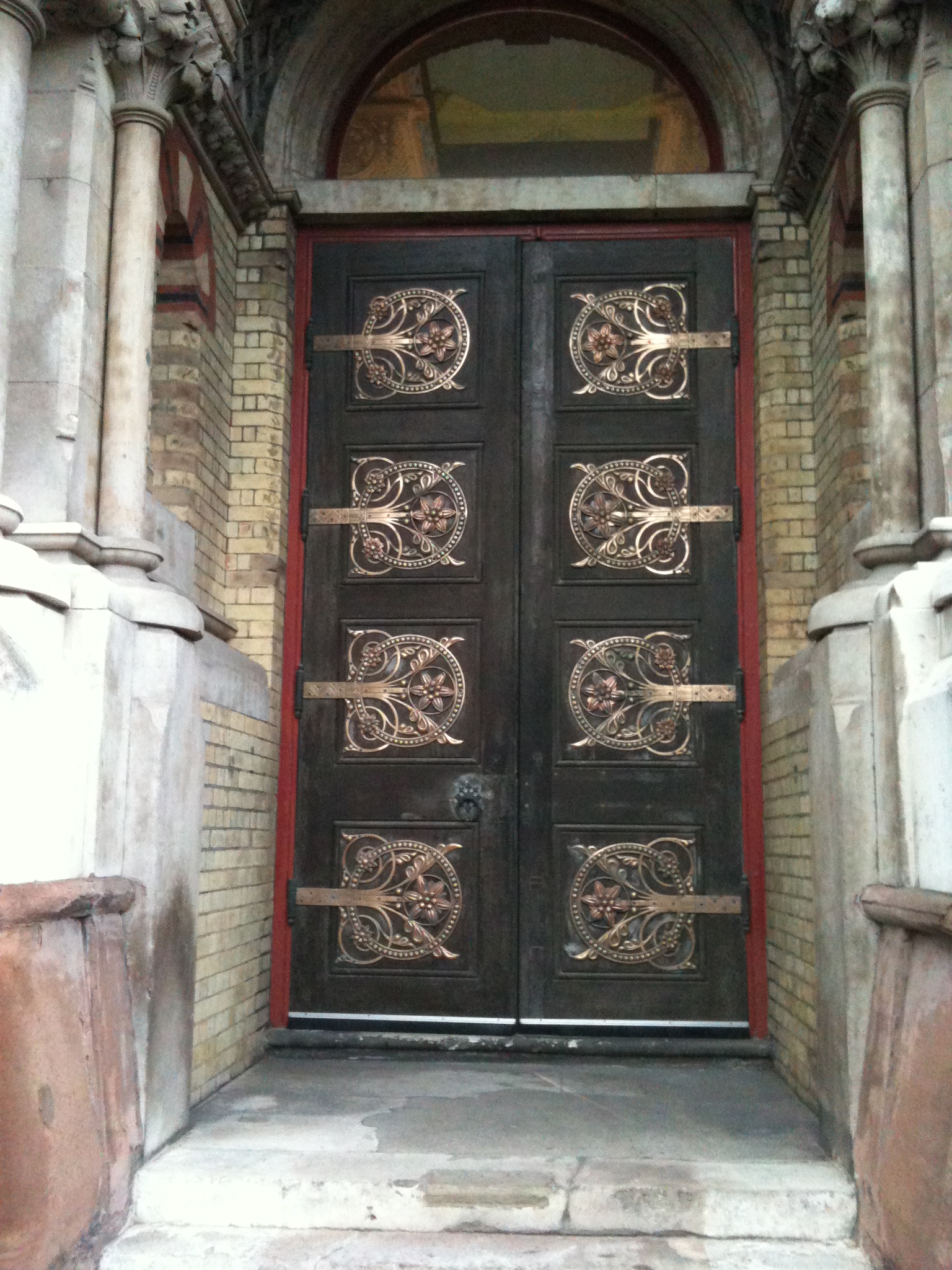 the doorway to the building is decorated with intricate ironwork