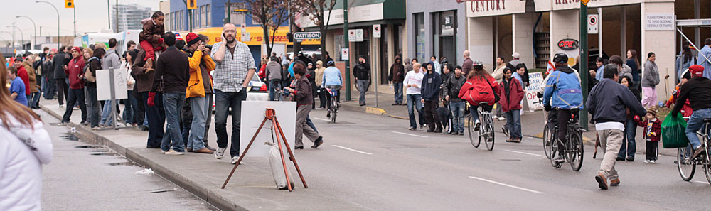 a crowd of people on bikes walking down the street