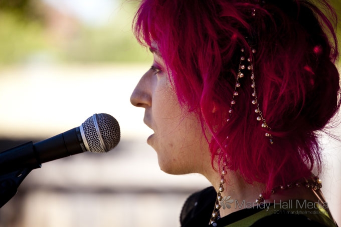 the young woman is speaking on a microphone