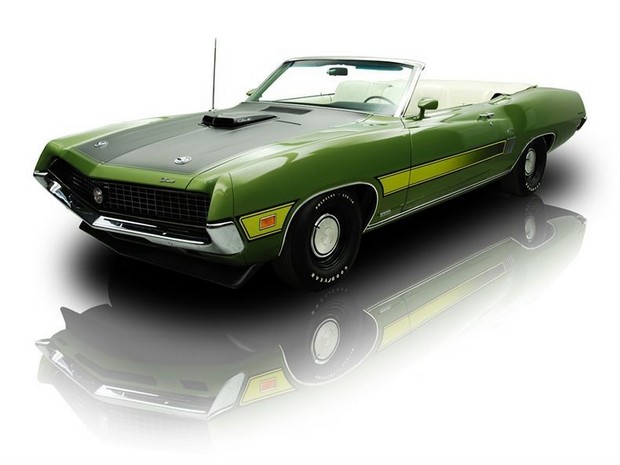 an old muscle car that is green and yellow