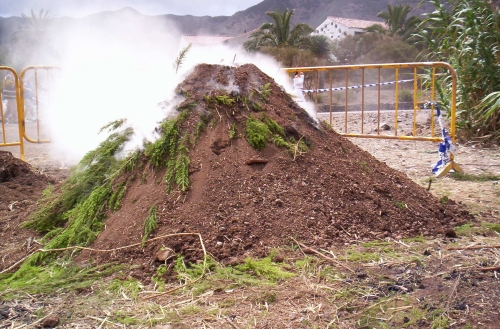 an earth pile sitting on top of a dirt field