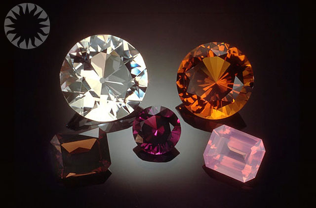 several different colored jewels are placed on a dark surface