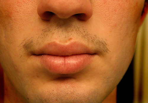 a close up of someones face with an unmade mustache