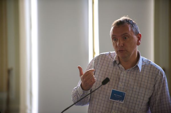 a man giving a speech at a conference
