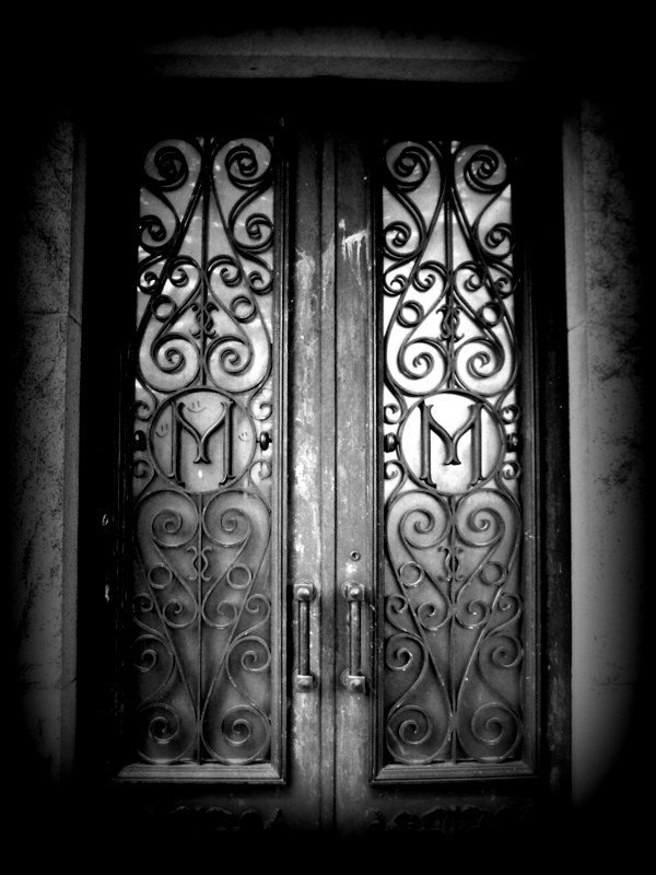 an old fashioned iron door is pictured with intricate ironwork