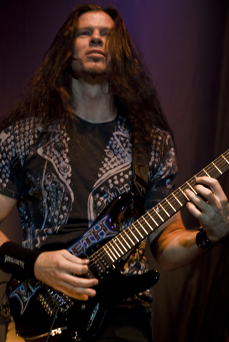 a person with long hair holding a guitar
