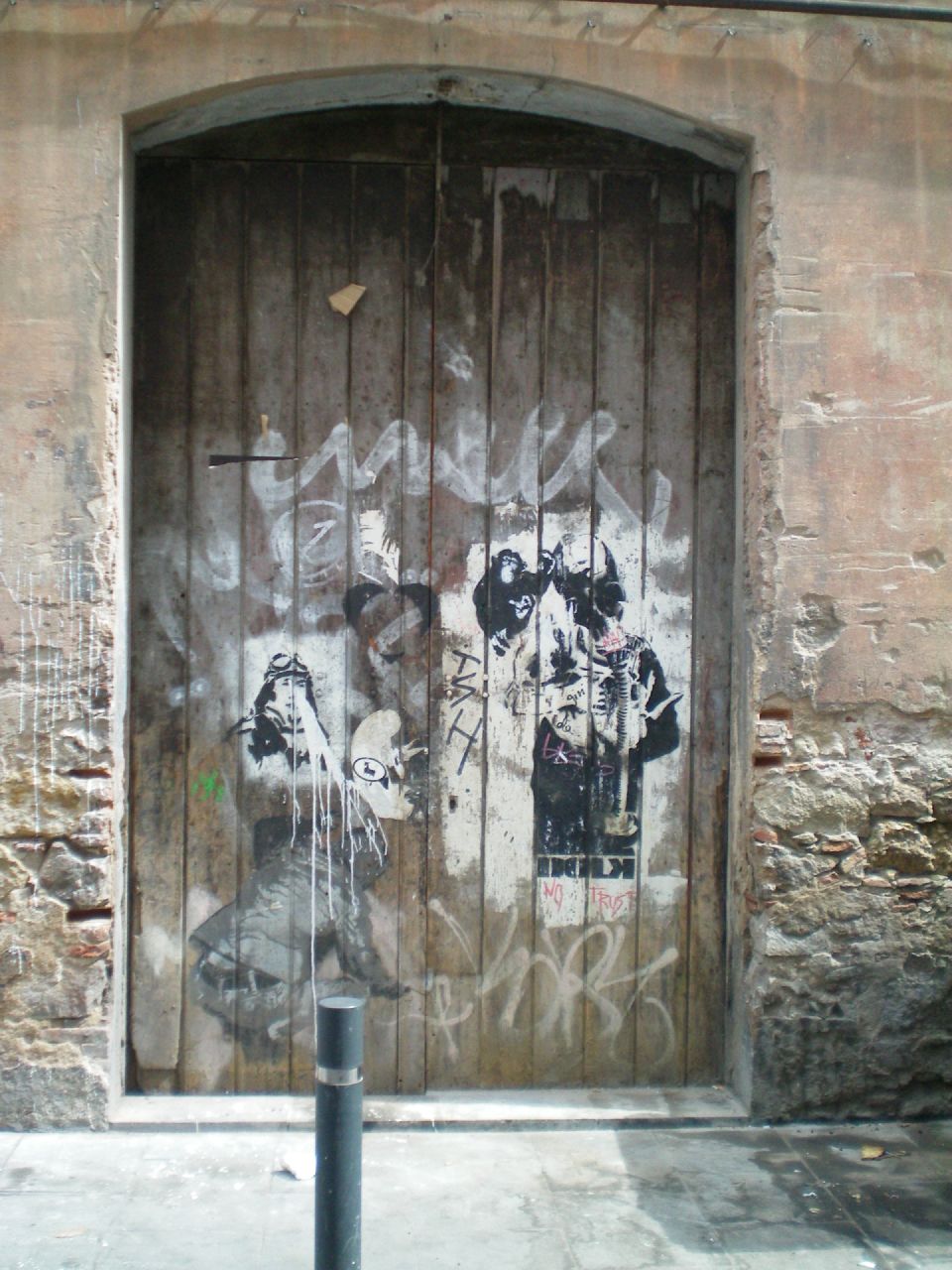 graffiti on a brick building with a wooden door