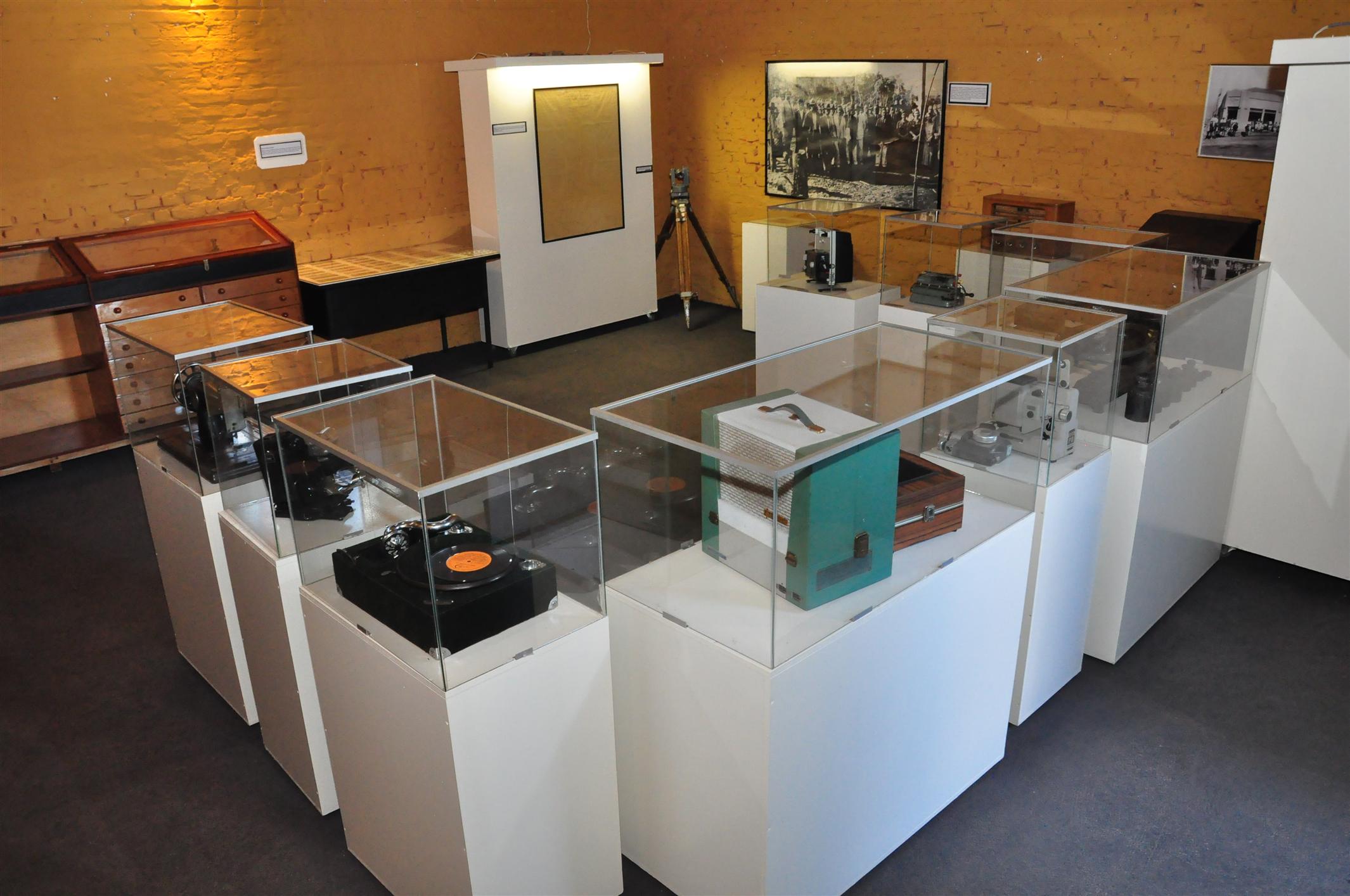 a display case in a room with several old items