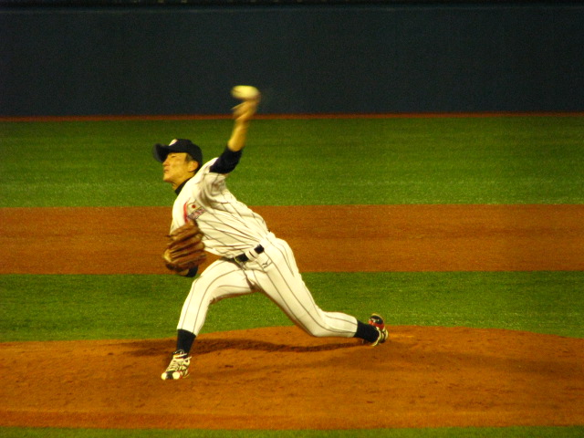 the pitcher in uniform is throwing the ball