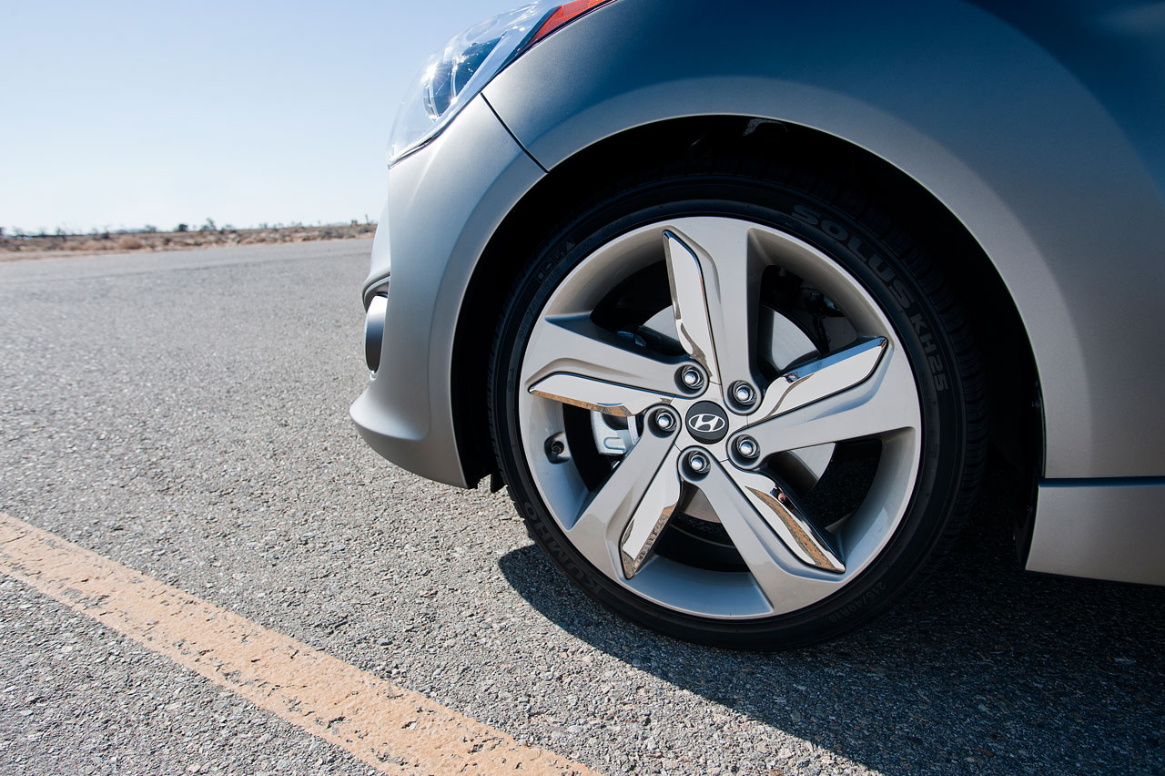 wheel hubs on the rim of a car driving down a road