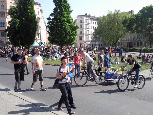 a large group of people on bikes and some in the street