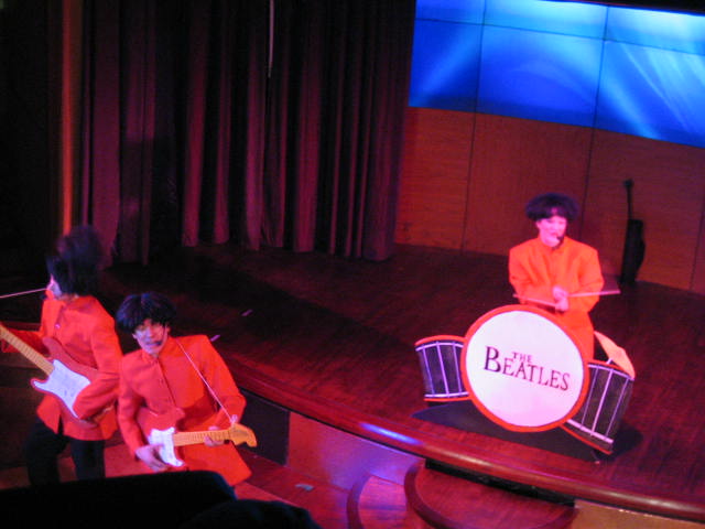 two little girls are playing a song on the drum set
