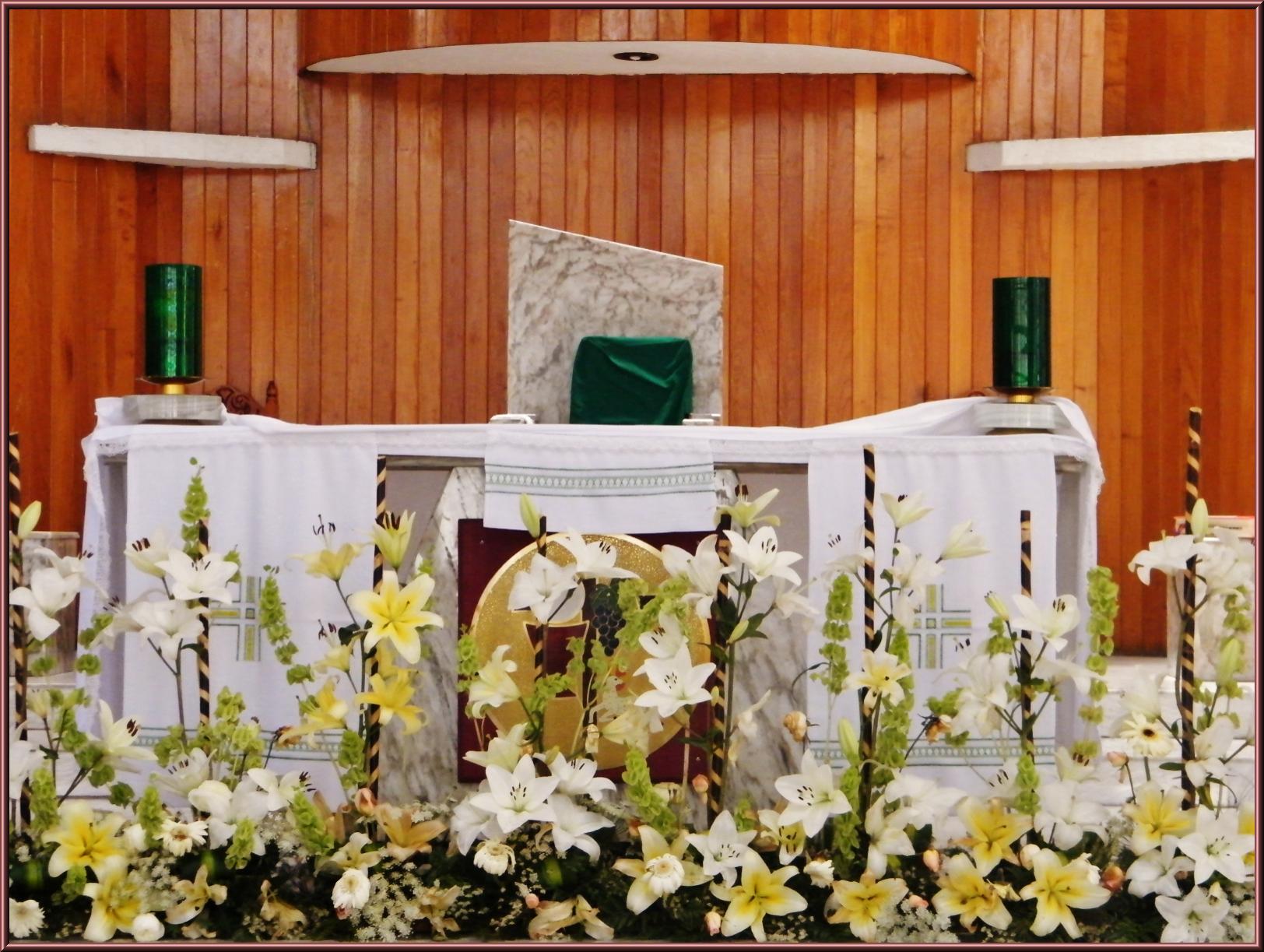 a mantel with flowers around it on the center stage