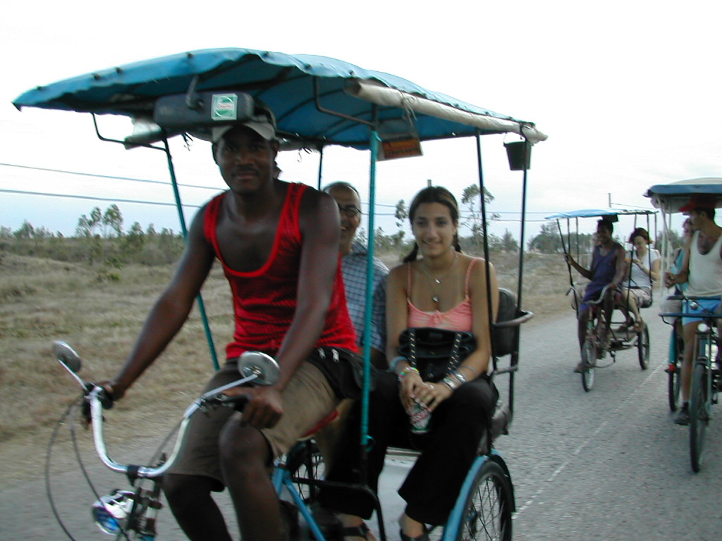 a group of people riding bicycles down a road