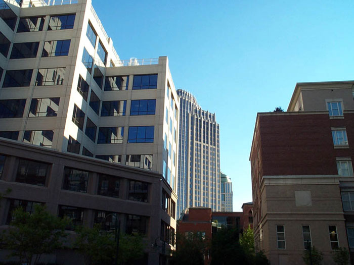 several large buildings in front of a blue sky