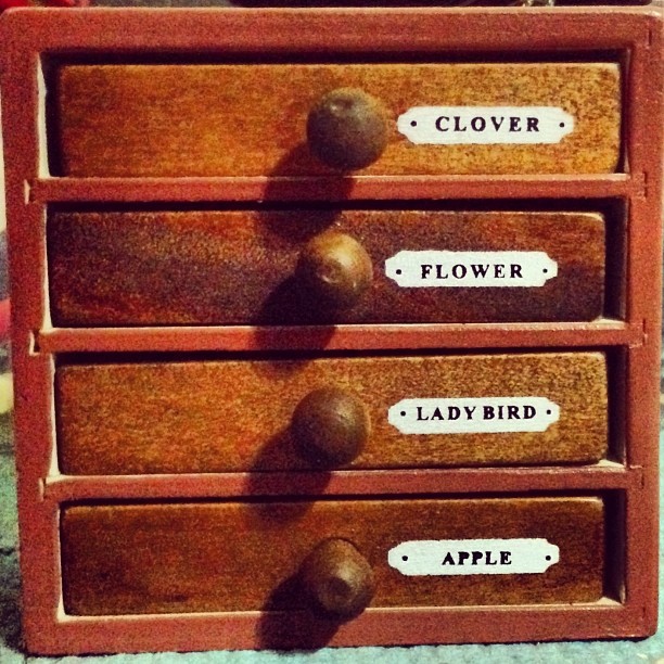 an old red drawer has many writing on it
