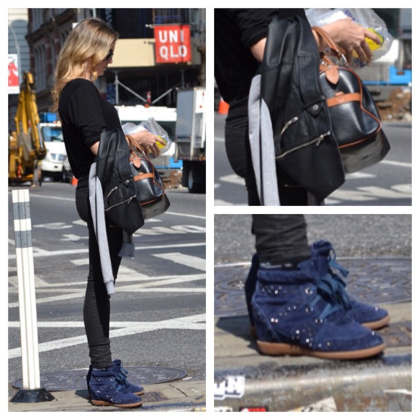 a girl standing with her purse and shoes