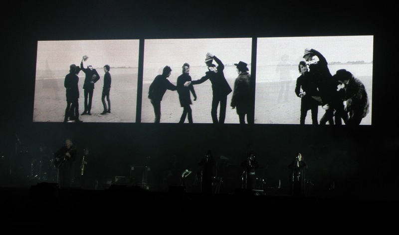 the silhouettes of the four people appear to be dancing