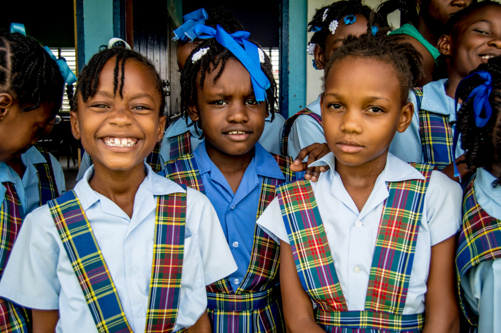 a group of schoolgirls are standing in front of a building