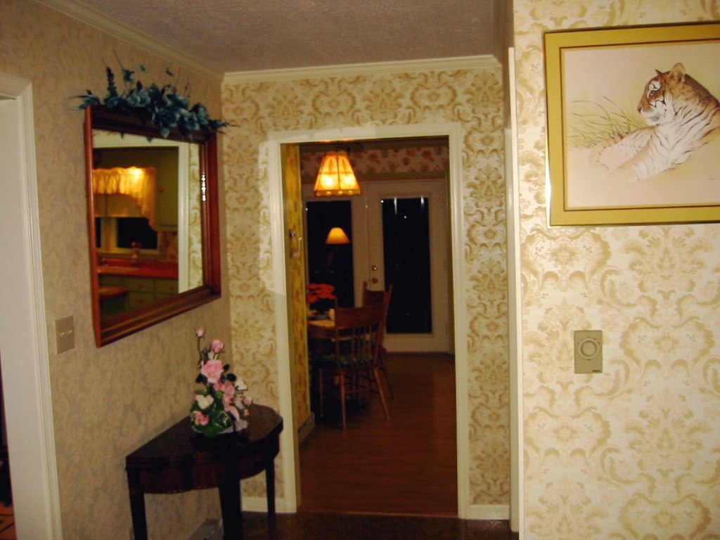 a very nice looking room with paintings and pictures on the wall