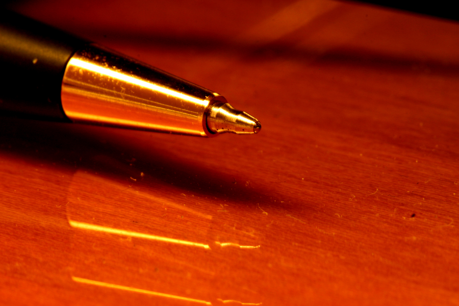 a pen sitting on top of a wooden desk