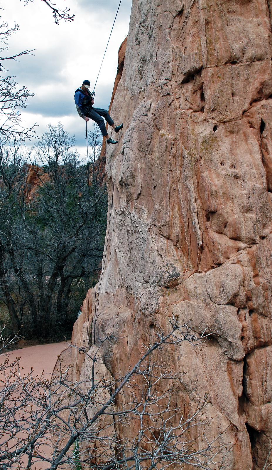 a person climbing up the side of a rock