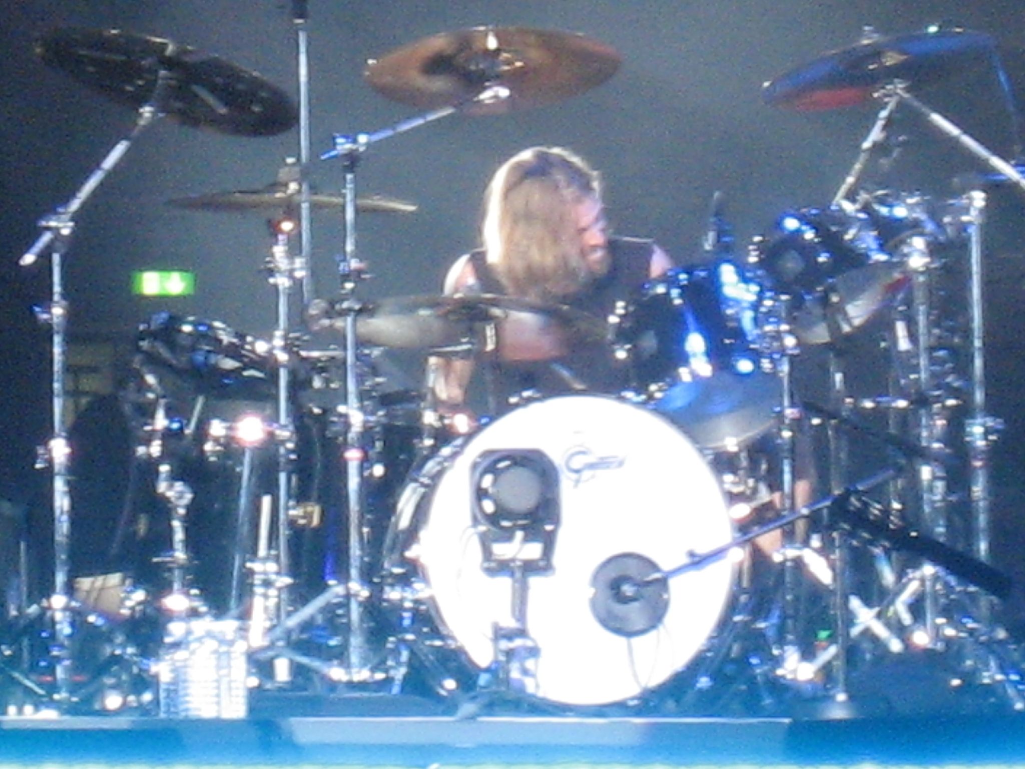 a female drummer behind the drums in front of her
