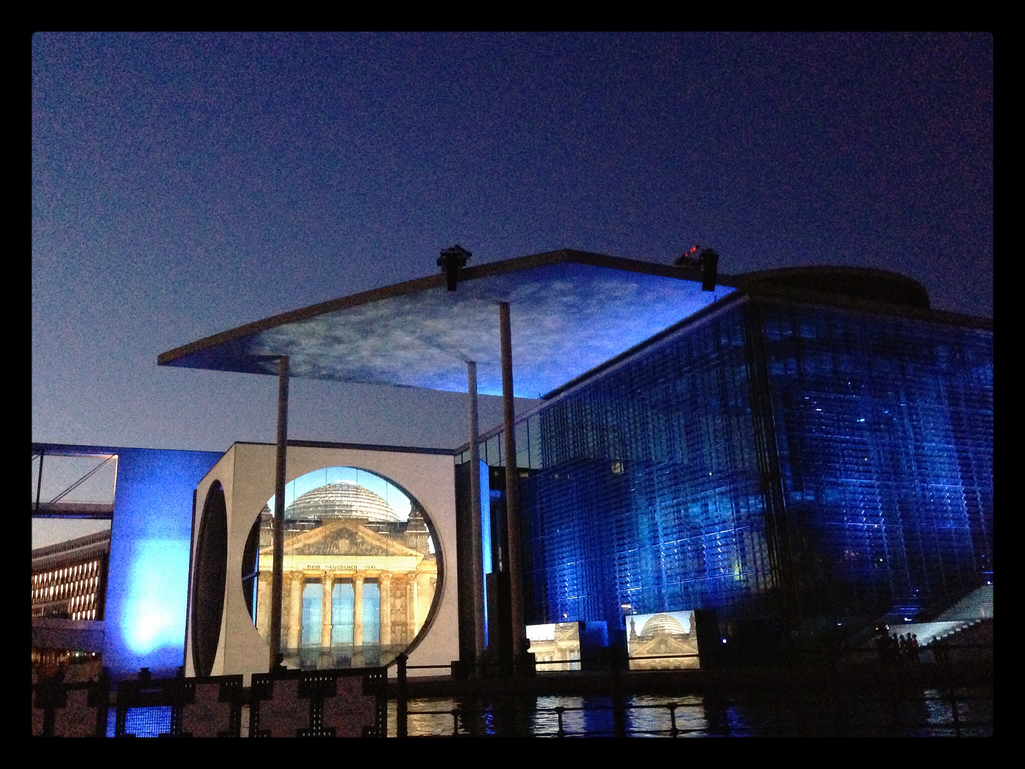 a large building with two birds sitting on top of it