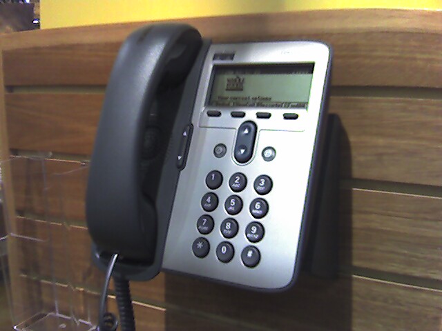 a telephone mounted to a wall next to a counter