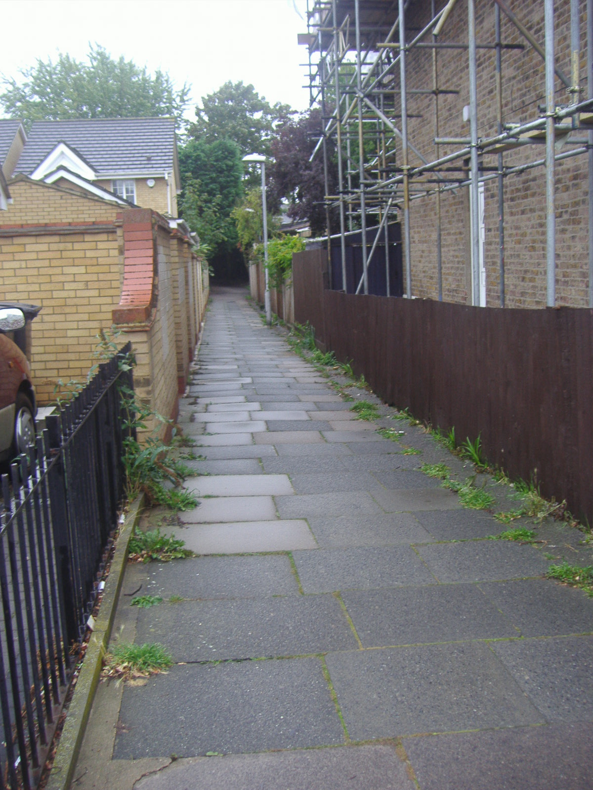 a brick path lined with scaffolding and scaffolding