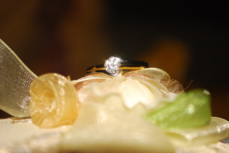 a beautiful wedding ring sits on a flower