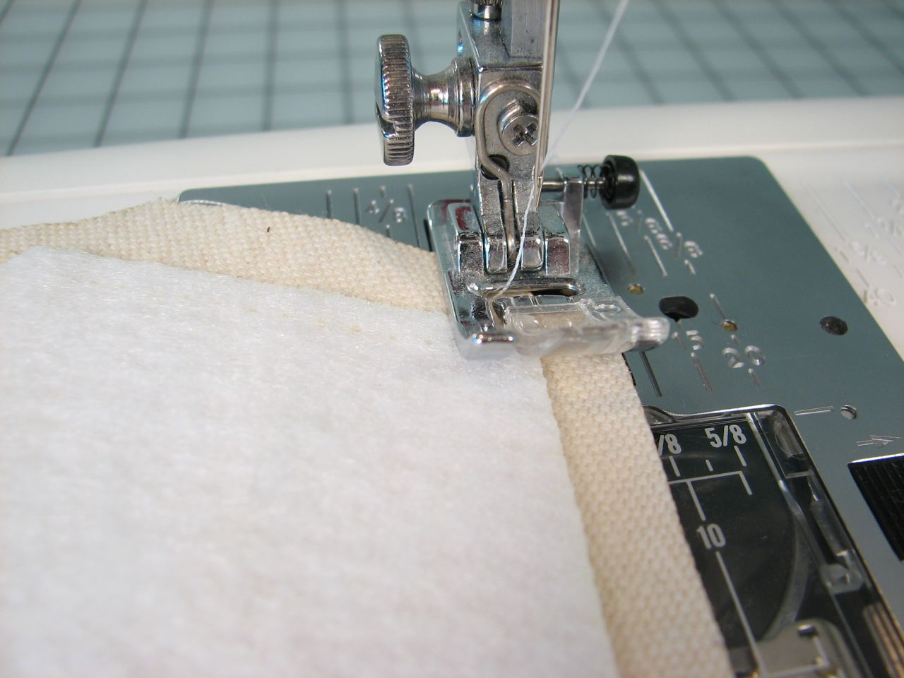 a close up of the sewing machine and needle on a cloth