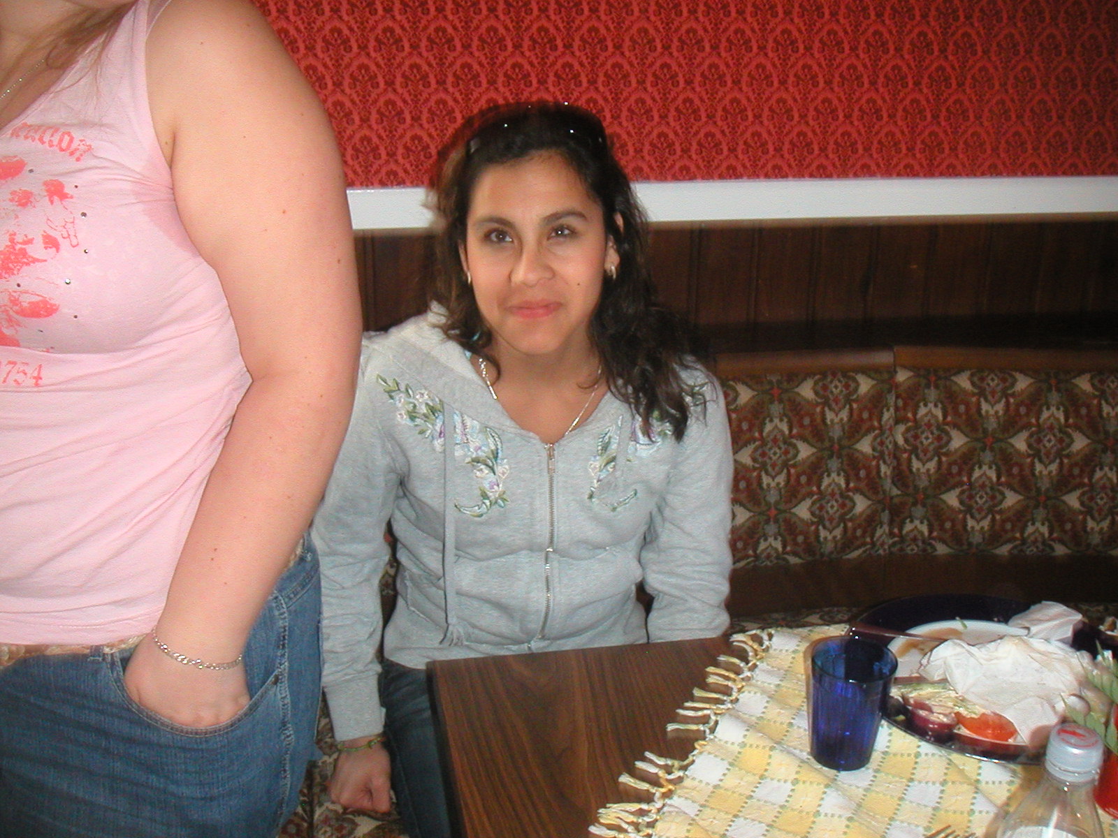 a woman sitting in front of a table in a restaurant