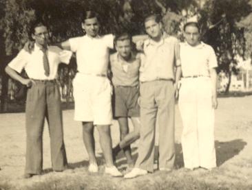 an old black and white po shows four men standing next to each other