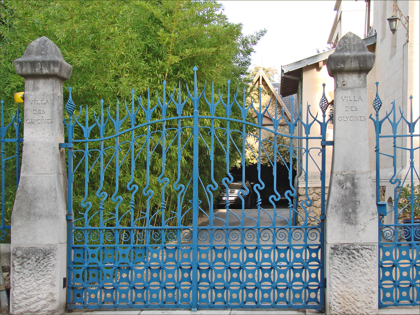 a long metal gate surrounded by two sculptures