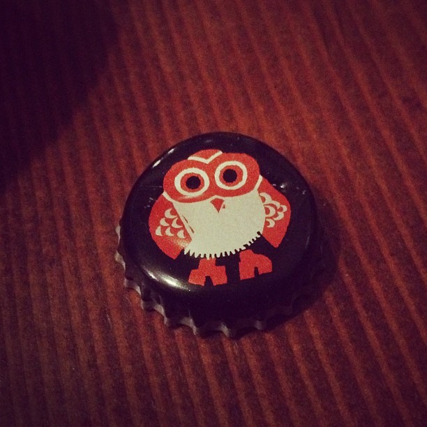an owl bottle cap sitting on top of a table