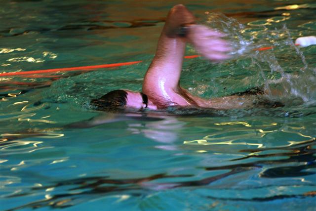 a man in the water doing an underwater maneuver