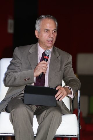 a man is sitting in a chair and holding a microphone