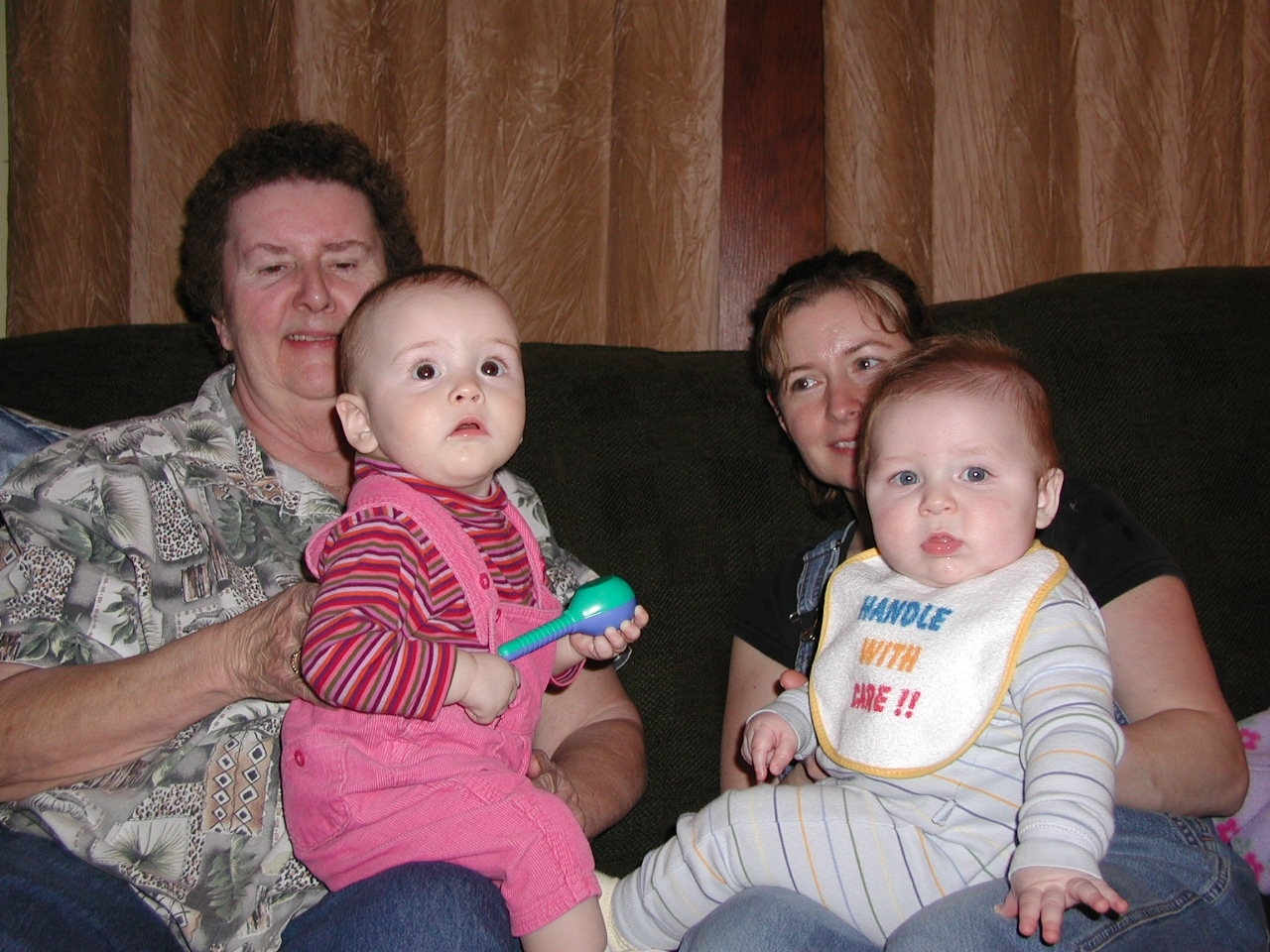 family on sofa holding baby and brushing teeth