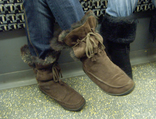 a person is wearing brown boots in a bus