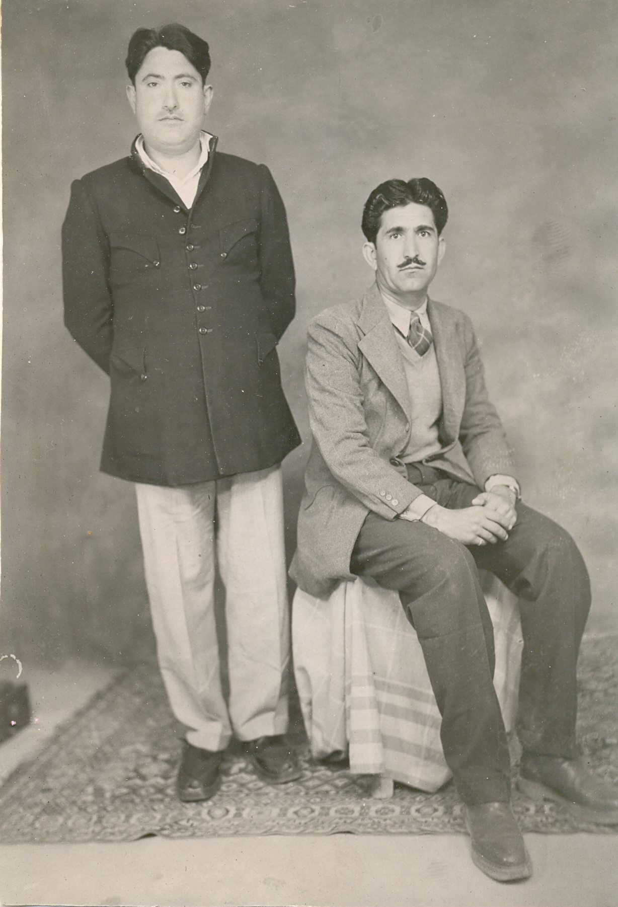 this is an old picture of two people in formal attire