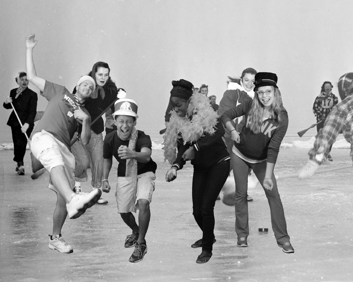 people in costumes skate on a snowy surface