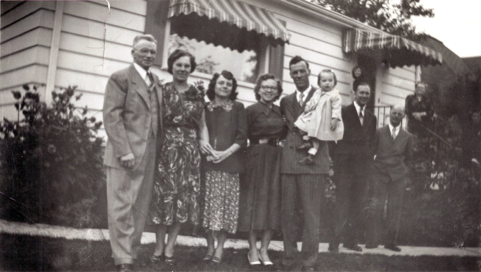 an old po of people in front of a house