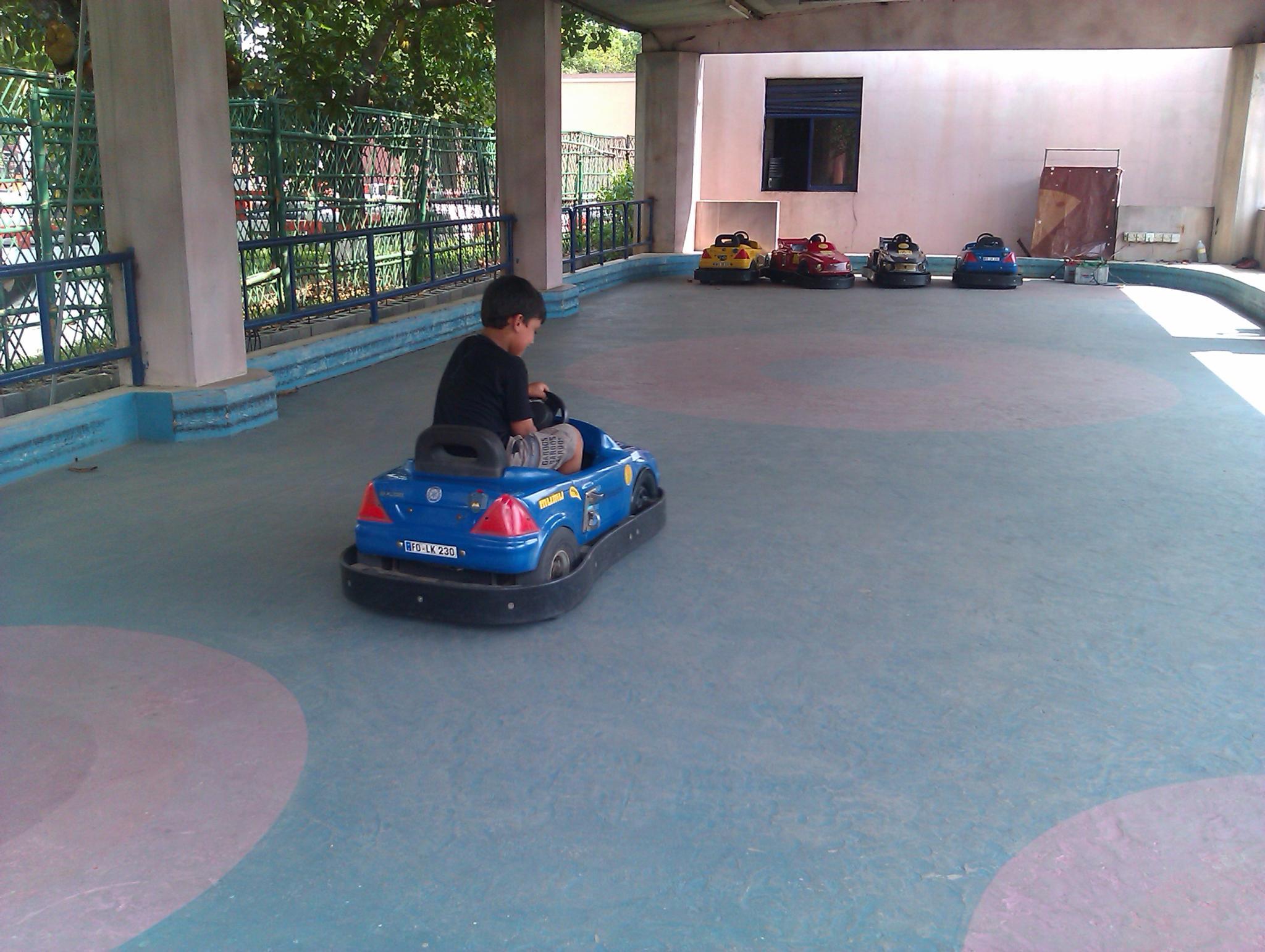 a child is riding on a toy car
